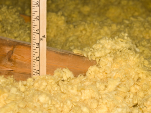 Gilroy's most trusted roofer inspects attic insulation before summer.