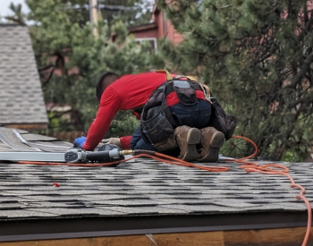 Roofing contractor installing new shingles in San Jose