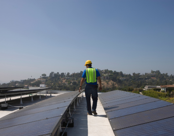 Technician inspecting solar panels in San Juan Bautista
