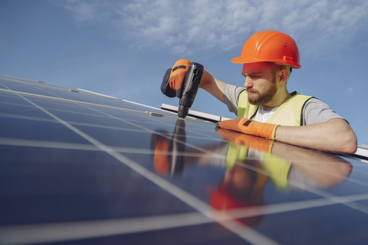 Affordable Roofing & Solar team maintaining solar panels